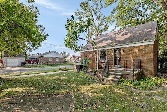 view of front of home with a garage and a front lawn