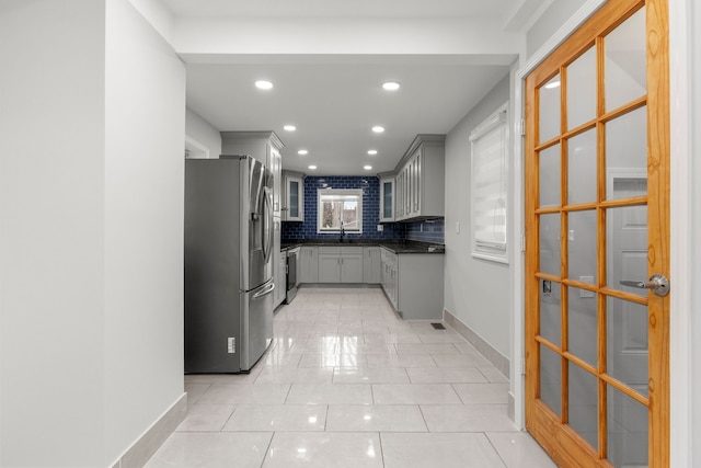 kitchen featuring gray cabinets, sink, stainless steel fridge with ice dispenser, and tasteful backsplash