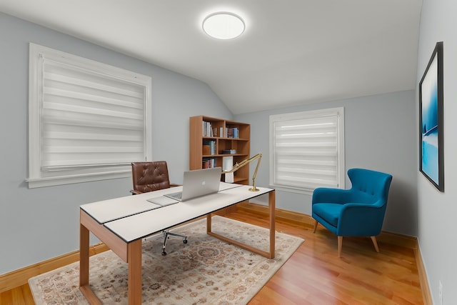 home office featuring hardwood / wood-style flooring and lofted ceiling