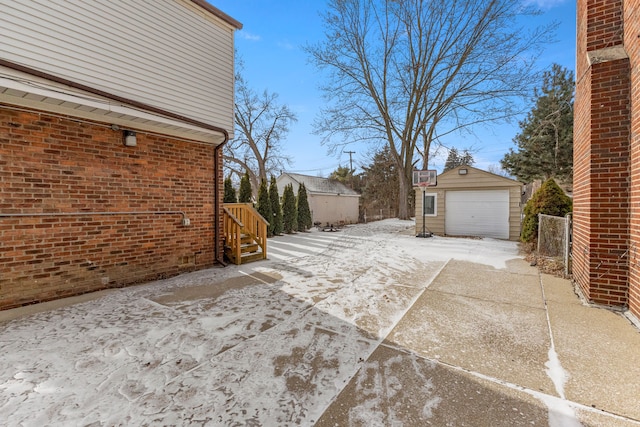 view of patio / terrace featuring a garage and an outbuilding