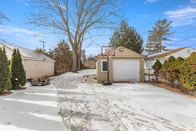 yard covered in snow featuring an outdoor structure and a garage