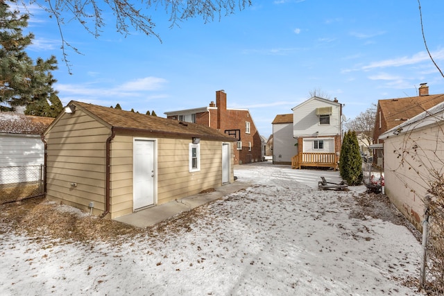 snow covered house with a wooden deck