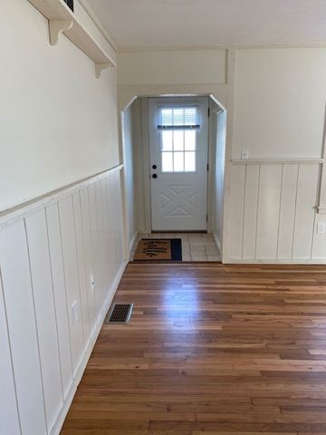 doorway with dark wood-type flooring