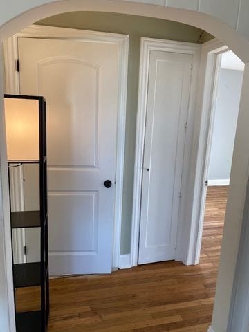 hallway with hardwood / wood-style floors