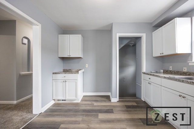 kitchen featuring white cabinetry and dark hardwood / wood-style floors