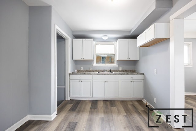 kitchen featuring white cabinetry and sink