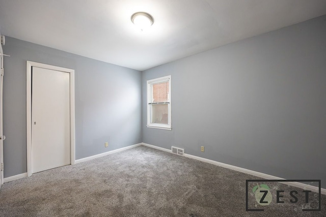 unfurnished room featuring carpet