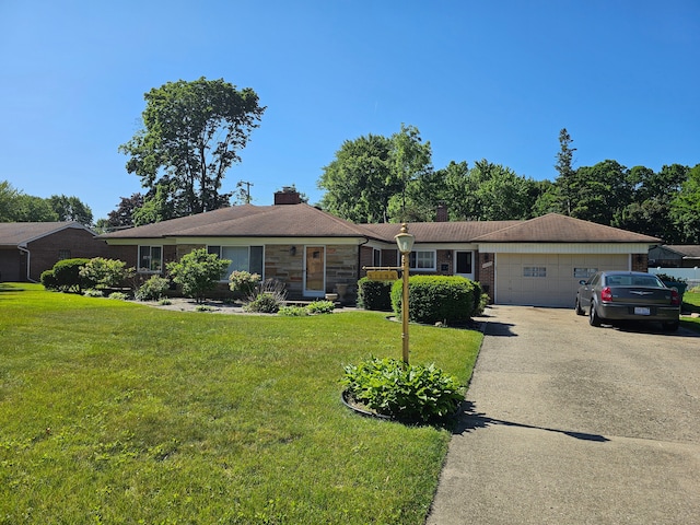 single story home featuring a garage and a front lawn