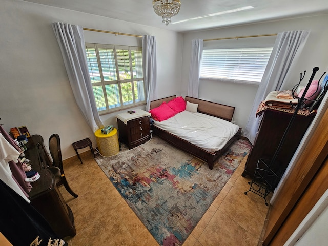 bedroom featuring a notable chandelier and light tile patterned flooring