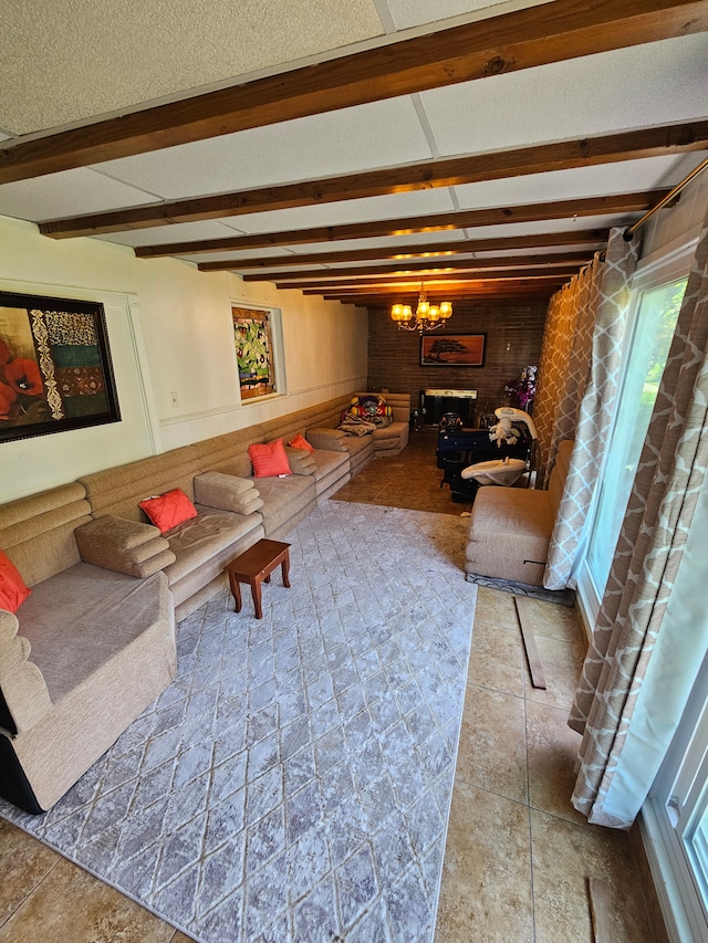 living room with a chandelier and beamed ceiling