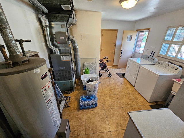 laundry area with independent washer and dryer, water heater, heating unit, and light tile patterned floors