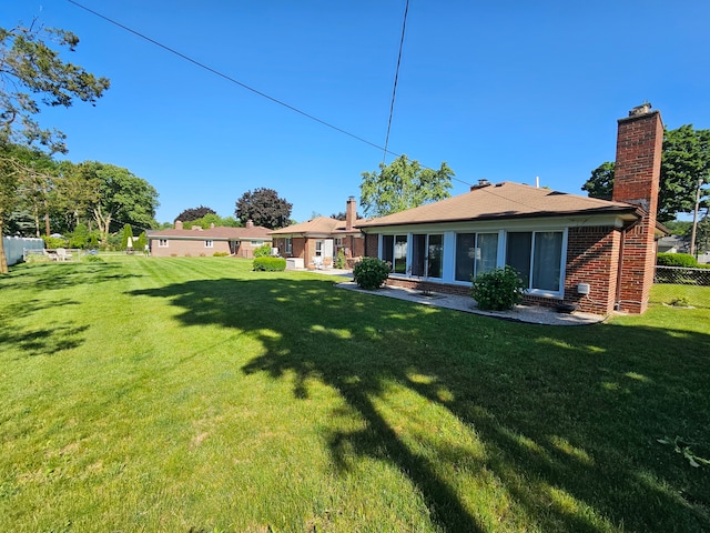 back of property featuring a yard