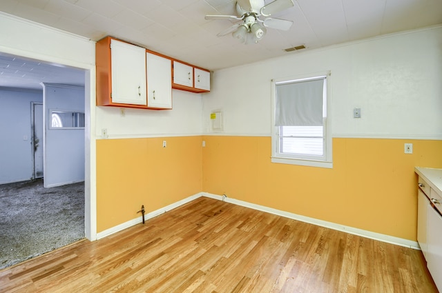 kitchen featuring white cabinets, light wood-type flooring, ceiling fan, and crown molding