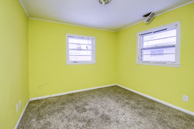 unfurnished room featuring carpet flooring, crown molding, and plenty of natural light