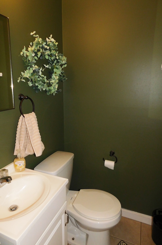 bathroom featuring tile patterned floors, vanity, and toilet