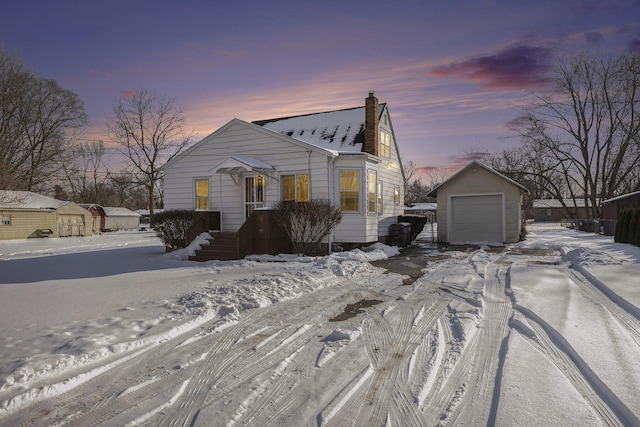 view of front of property with a garage and a storage unit