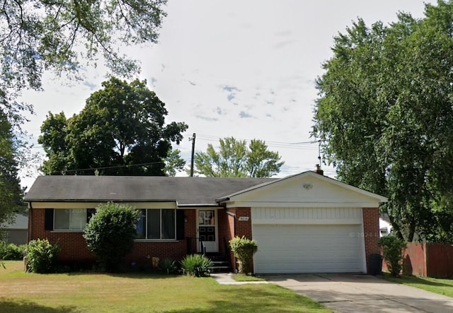 single story home featuring a front yard and a garage