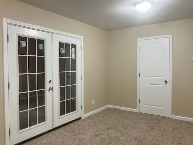 carpeted spare room with french doors