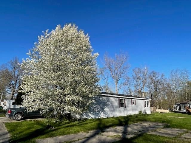 view of property exterior featuring a lawn