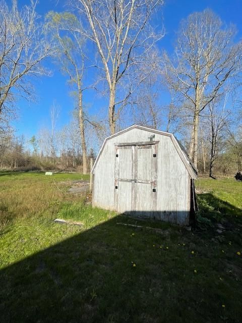 view of outbuilding with a yard