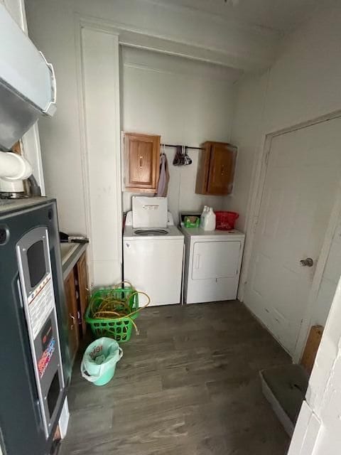 clothes washing area featuring cabinets, dark hardwood / wood-style flooring, and independent washer and dryer