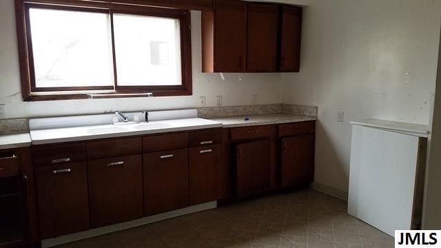 kitchen with sink and dark brown cabinets