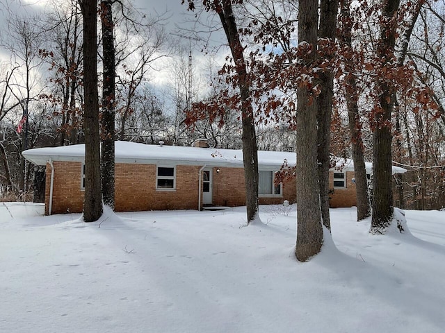 view of snow covered rear of property