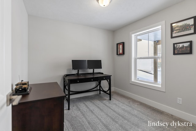 office with baseboards and carpet floors