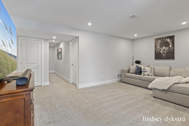 living room with recessed lighting, light colored carpet, and baseboards