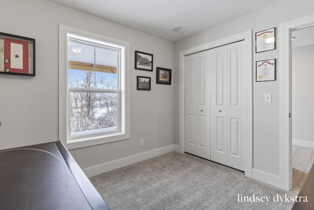 interior space featuring visible vents, baseboards, and carpet flooring