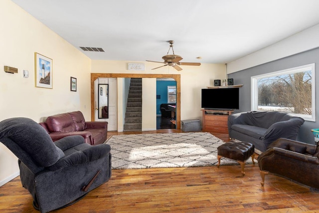 living room featuring wood-type flooring and ceiling fan