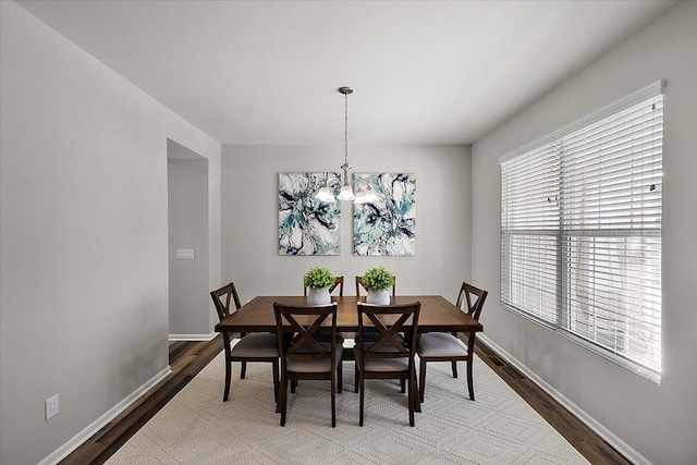 dining space with an inviting chandelier and hardwood / wood-style floors