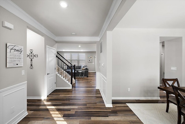 entryway with dark wood-type flooring and ornamental molding