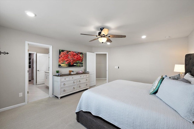 carpeted bedroom with ceiling fan and ensuite bathroom