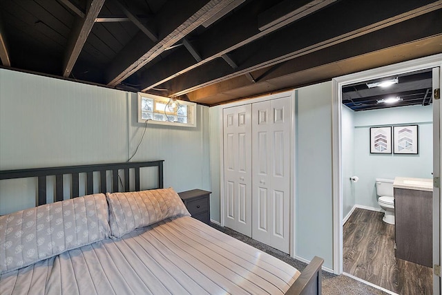 bedroom featuring hardwood / wood-style flooring and ensuite bathroom