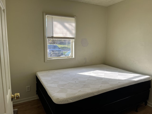 bedroom with hardwood / wood-style flooring