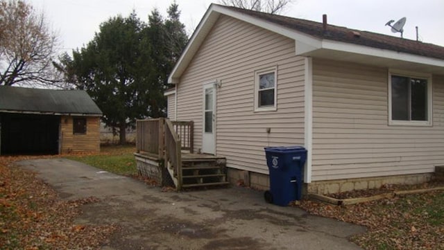 view of home's exterior with a garage and an outdoor structure