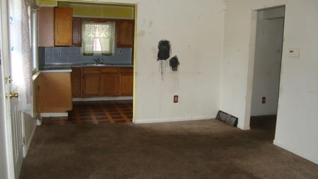 kitchen featuring sink and dark colored carpet