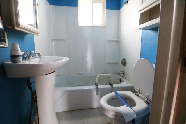 bathroom featuring tile patterned flooring, bathtub / shower combination, and toilet