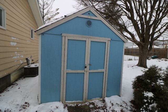 snow covered structure featuring central air condition unit