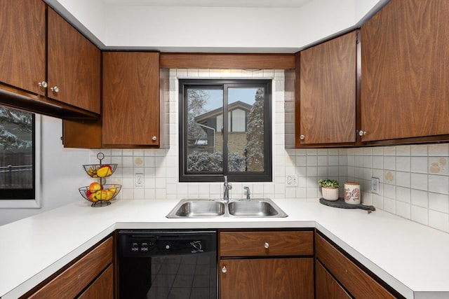 kitchen with sink, decorative backsplash, and black dishwasher