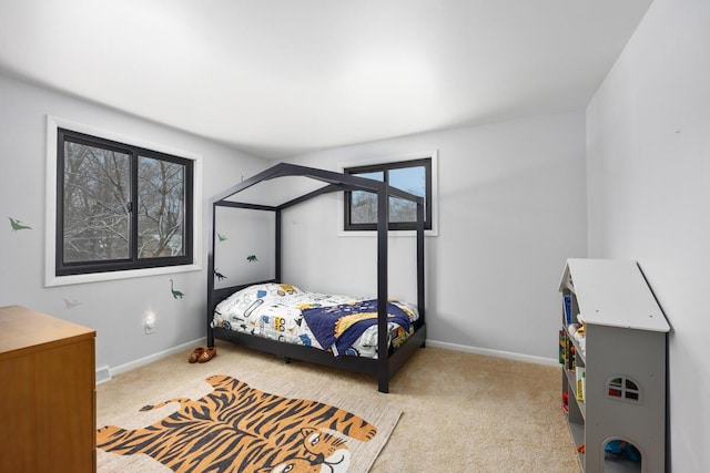 carpeted bedroom featuring multiple windows