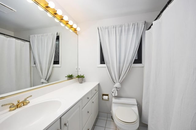 bathroom featuring tile patterned floors, vanity, and toilet