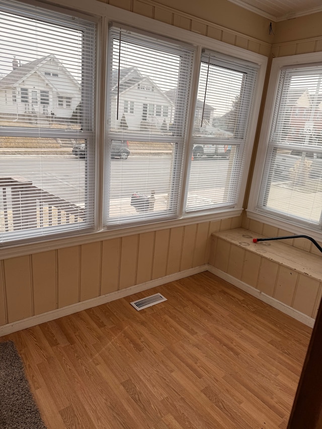 unfurnished sunroom with visible vents