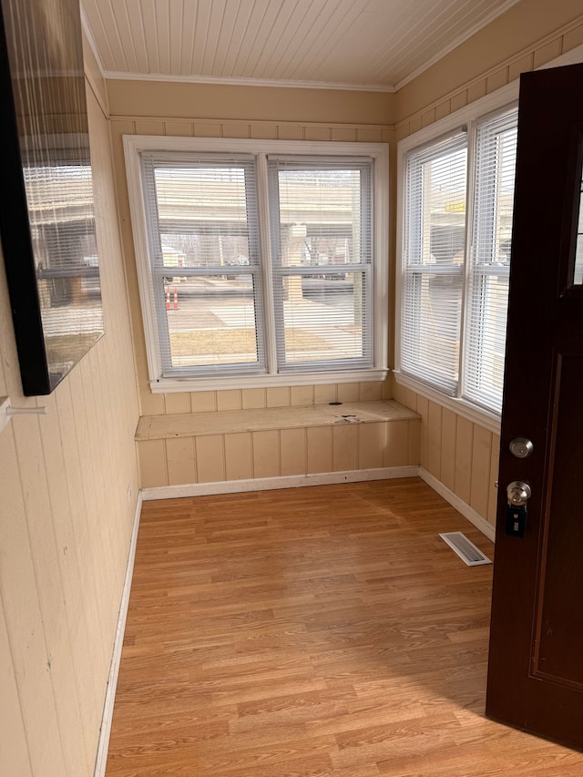 unfurnished sunroom featuring wooden ceiling and visible vents