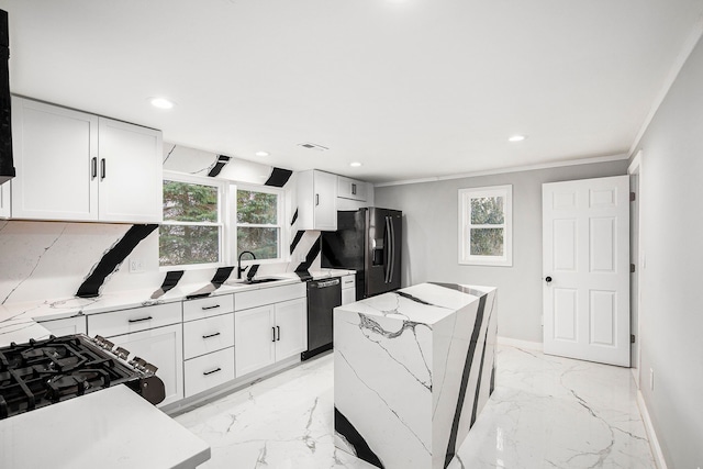 kitchen featuring light stone countertops, white cabinets, black appliances, sink, and ornamental molding