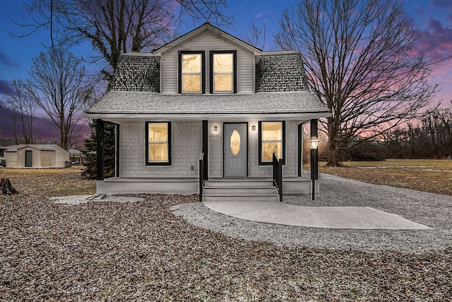 view of front facade featuring a porch and a shingled roof