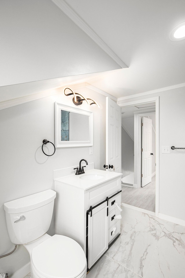 bathroom with vanity, toilet, and crown molding