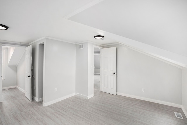 bonus room featuring visible vents, baseboards, and light wood-style floors