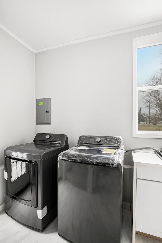 laundry room with laundry area, electric panel, independent washer and dryer, and ornamental molding